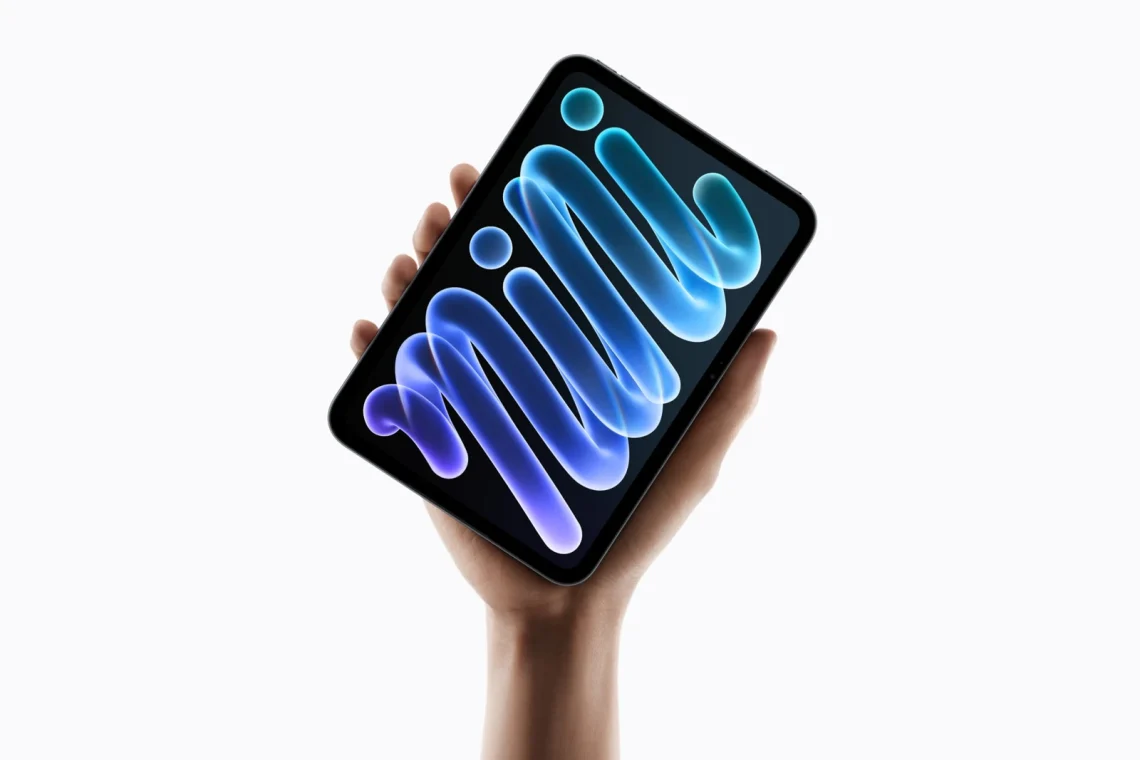 The redesigned iPad mini held upright in one hand.