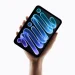 The redesigned iPad mini held upright in one hand.