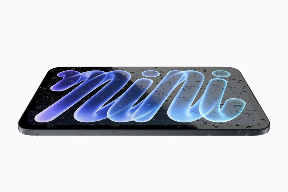 The redesigned iPad mini lying flat with water droplets on its screen.