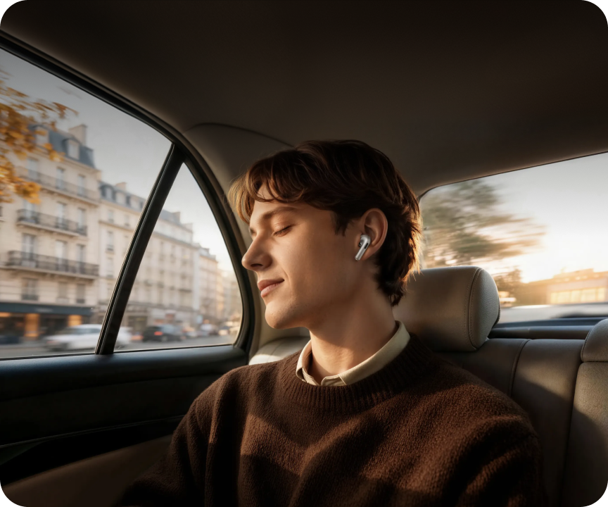 Person wearing OPPO Enco X4 earbuds while sitting beside a car window