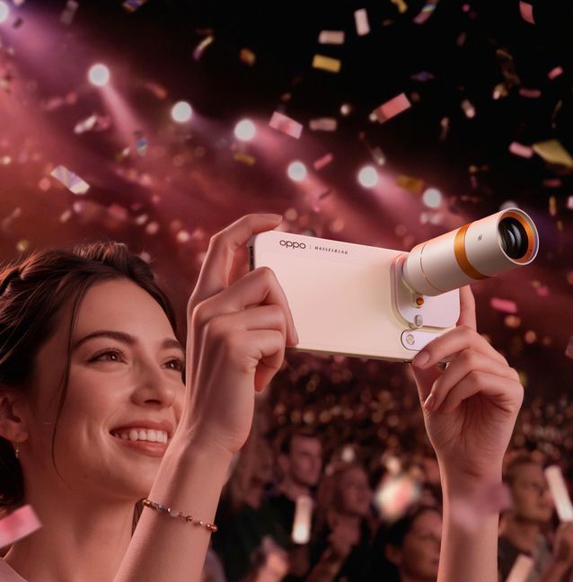 OPPO Find X10 Pro Max shown with a Hasselblad teleconverter attachment at a concert