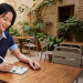 Person using a stylus with OPPO Pad Mini at a café table