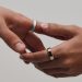 Two hands wearing silver and gold Oura Ring 5 smart rings