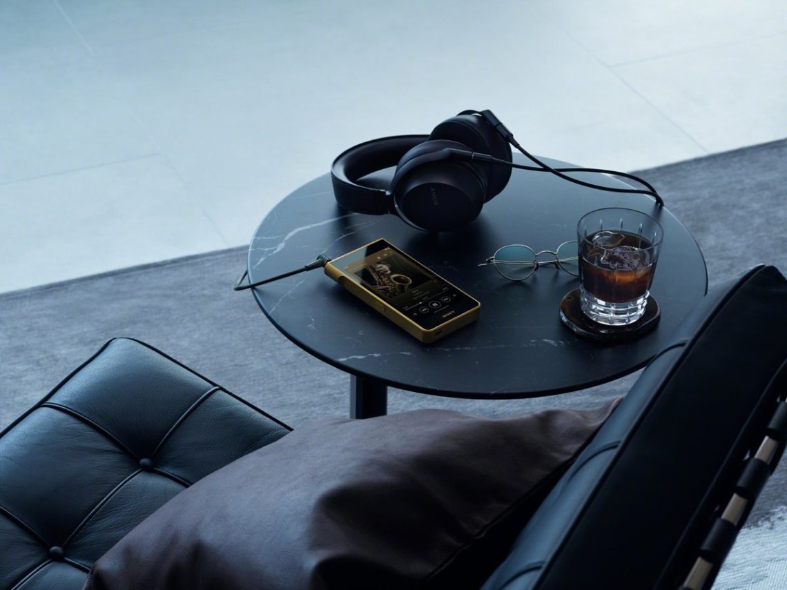 Sony NW-WM1ZM3 Walkman beside over-ear headphones on a table