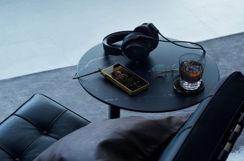 Sony NW-WM1ZM3 Walkman beside over-ear headphones on a table